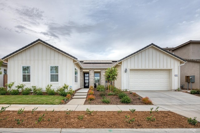 view of front of house featuring solar panels and a garage