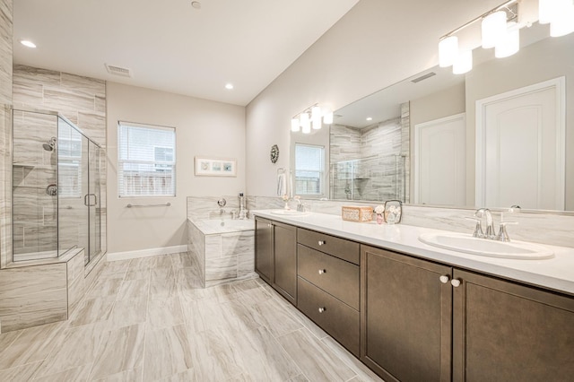 bathroom featuring vanity and separate shower and tub