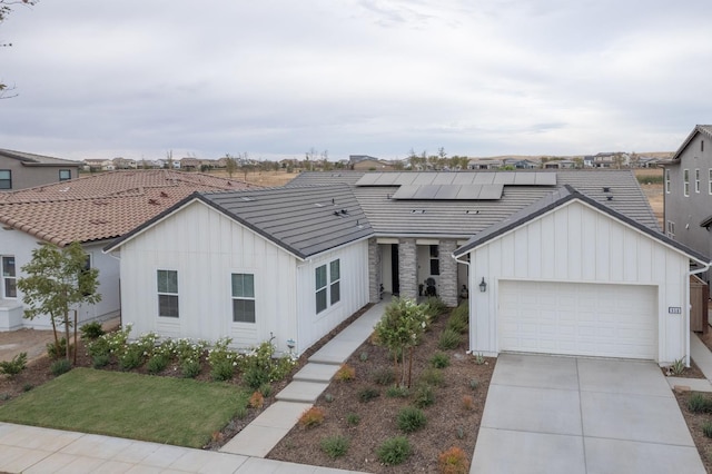 view of front of house featuring solar panels and a garage