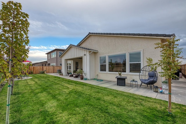 rear view of house with a yard and a patio area