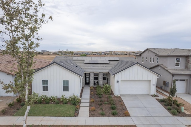 view of front of home with a garage and solar panels