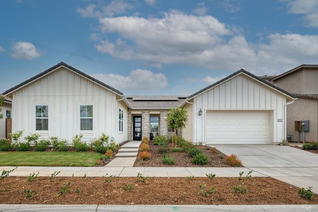 view of front of house with solar panels and a garage