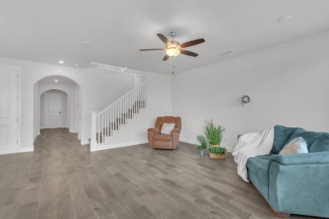 living room featuring ceiling fan and light hardwood / wood-style flooring