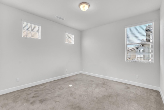 spare room featuring light colored carpet