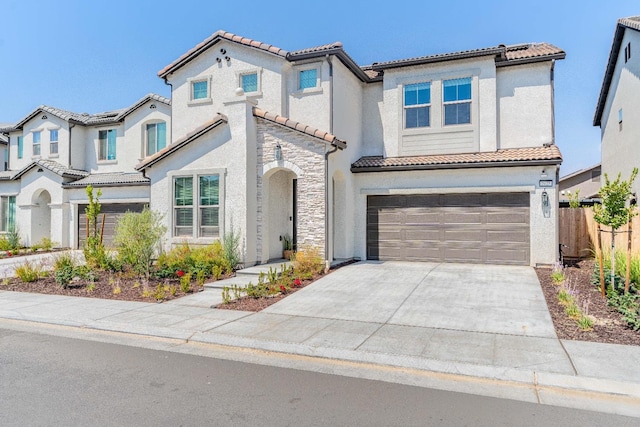 mediterranean / spanish-style home with a garage