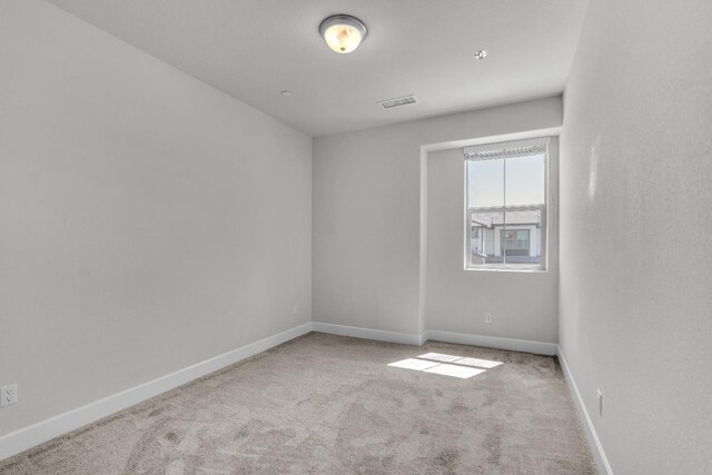 spare room with light carpet