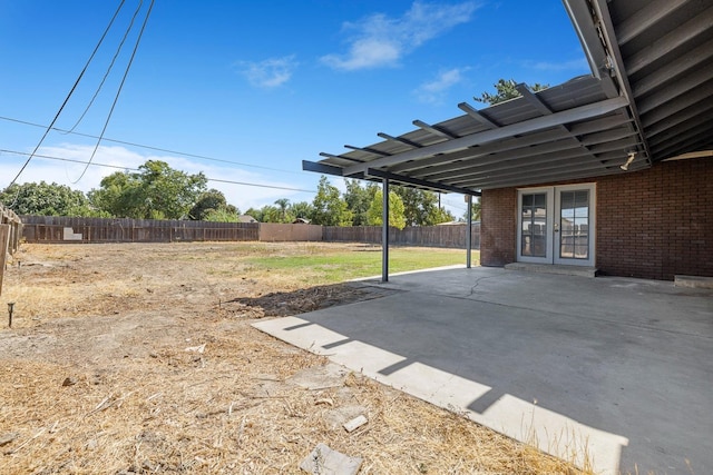 view of yard featuring a patio area and french doors