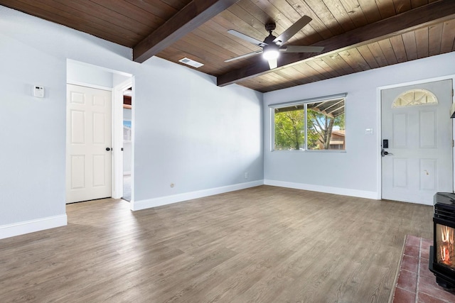 entryway with wood ceiling, beamed ceiling, a wood stove, ceiling fan, and hardwood / wood-style floors