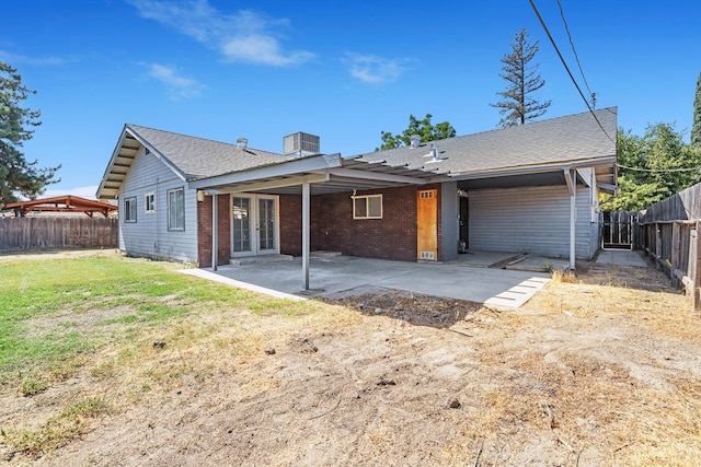 back of house featuring a lawn and a patio area