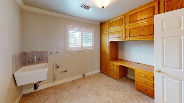 washroom featuring gas dryer hookup, ornamental molding, washer hookup, and cabinets