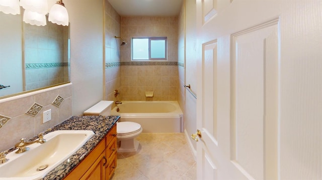 full bathroom with vanity, tile patterned floors, tiled shower / bath, and toilet