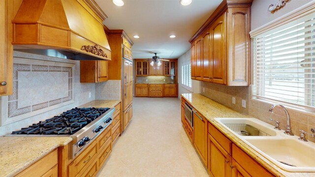 kitchen featuring custom range hood, backsplash, appliances with stainless steel finishes, and a wealth of natural light