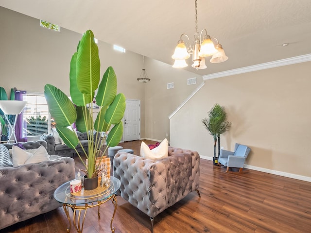 living room with ornamental molding, a notable chandelier, and dark hardwood / wood-style floors