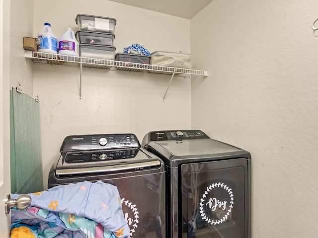 washroom with washing machine and clothes dryer