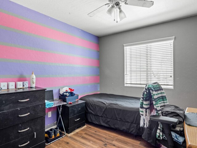 bedroom featuring ceiling fan and hardwood / wood-style floors