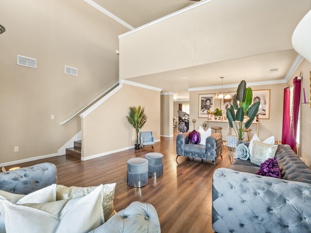 living room featuring ornamental molding, hardwood / wood-style flooring, and a chandelier