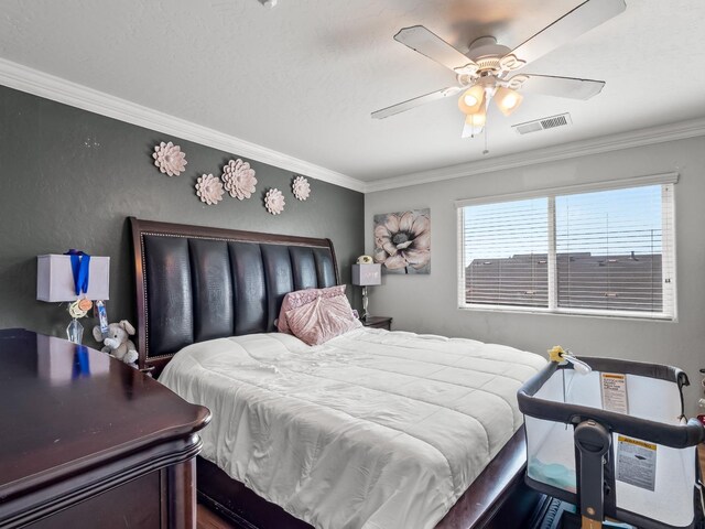 bedroom featuring ornamental molding and ceiling fan