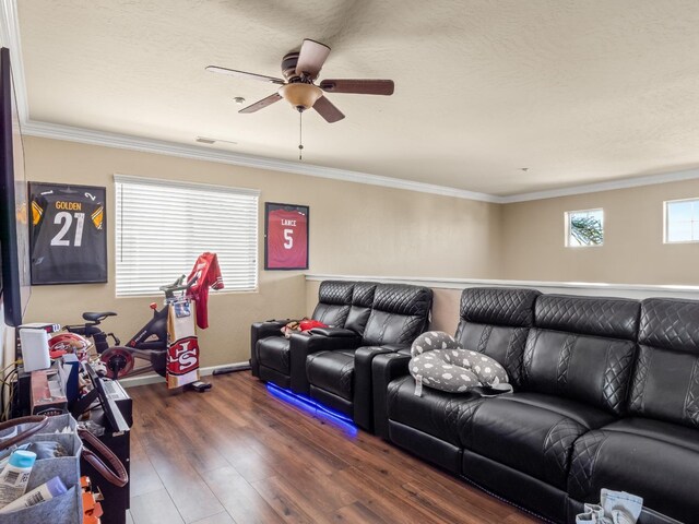 living room featuring crown molding, ceiling fan, dark wood-type flooring, and a wealth of natural light