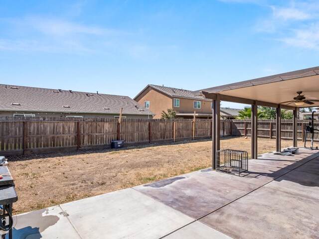 view of yard featuring ceiling fan and a patio area