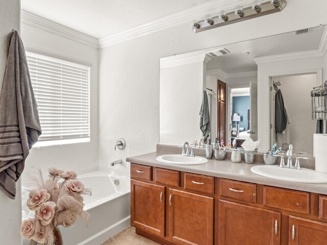 bathroom featuring vanity, a tub to relax in, and ornamental molding