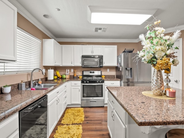 kitchen featuring black appliances, ornamental molding, sink, and white cabinetry