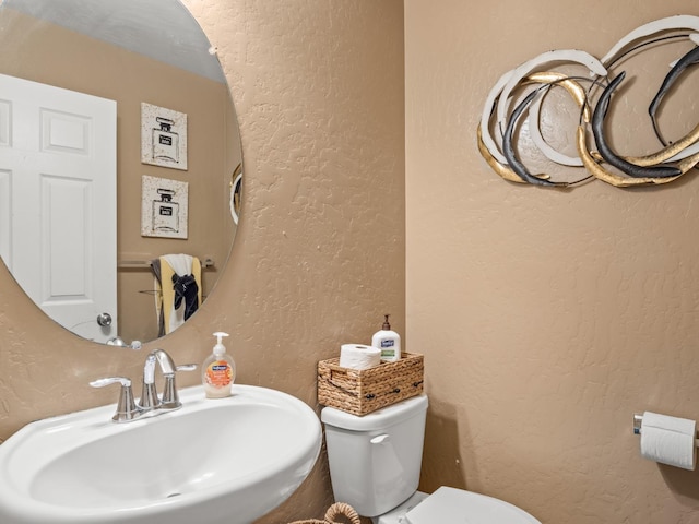 bathroom featuring sink and toilet