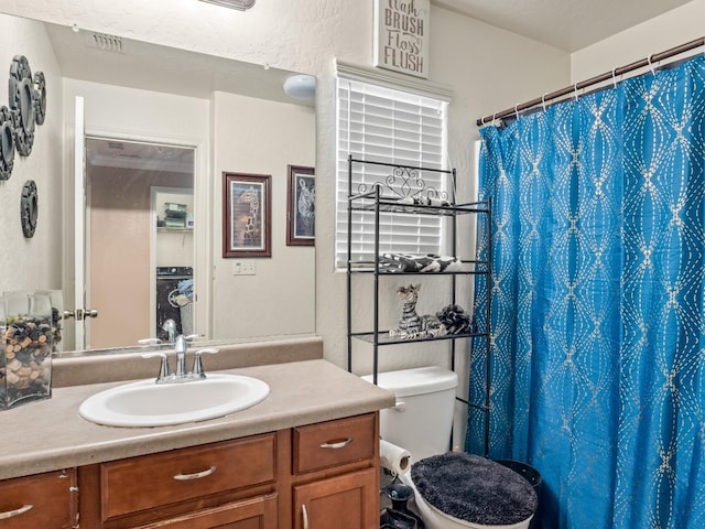 bathroom with vanity, toilet, and curtained shower