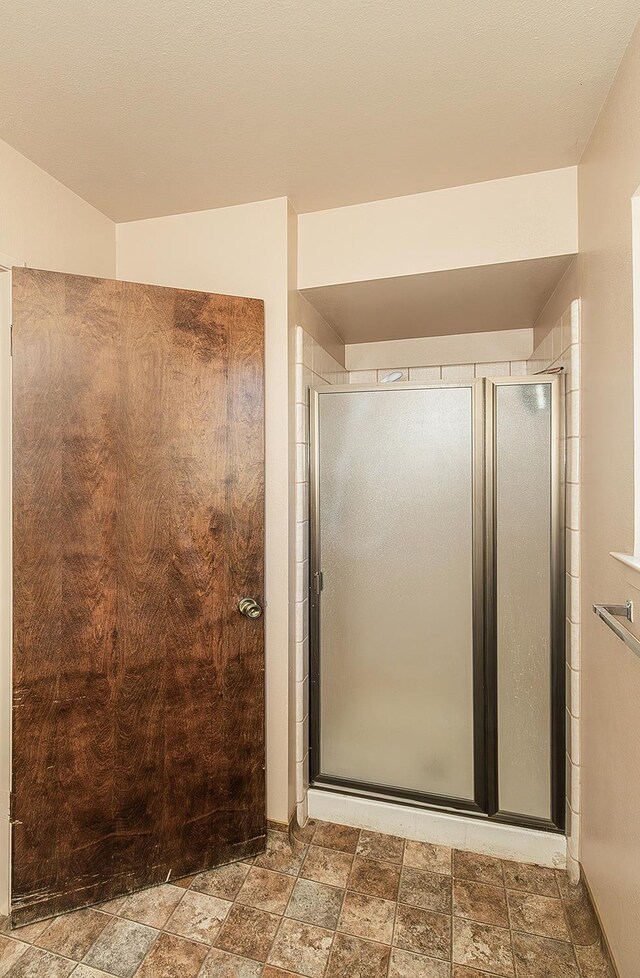 bathroom featuring a shower with door