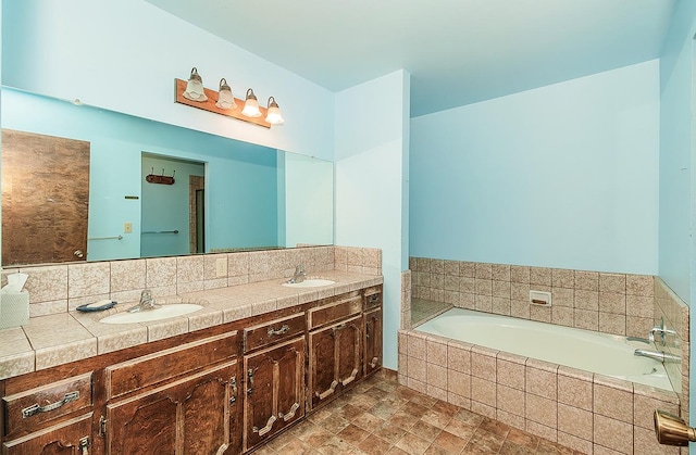 bathroom with tiled bath and vanity