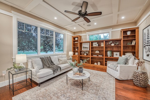 living room with ceiling fan, hardwood / wood-style floors, coffered ceiling, and a wealth of natural light