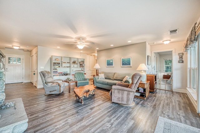 living room featuring ceiling fan and wood-type flooring