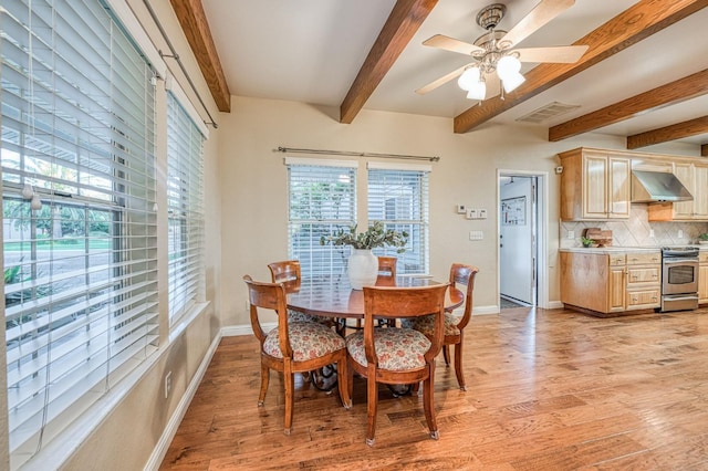 dining room with beamed ceiling, ceiling fan, and light hardwood / wood-style flooring