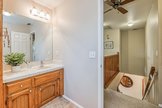 bathroom with ceiling fan and vanity