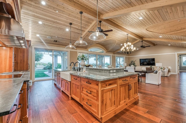 kitchen with ceiling fan with notable chandelier, dark hardwood / wood-style flooring, wooden ceiling, decorative light fixtures, and a spacious island