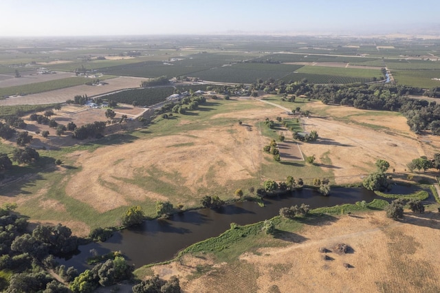 birds eye view of property featuring a rural view and a water view