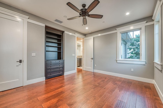 unfurnished bedroom featuring ceiling fan and hardwood / wood-style flooring