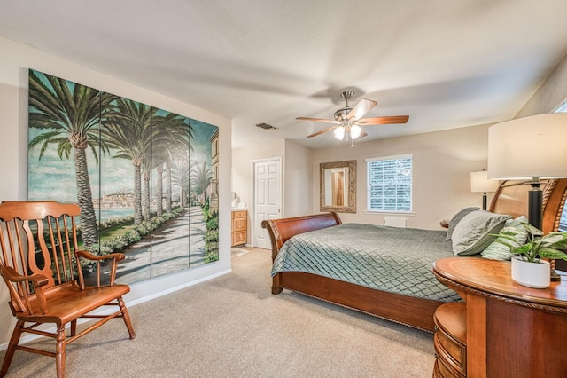 carpeted bedroom featuring ceiling fan and ensuite bathroom