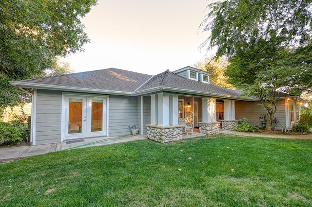 view of front facade featuring a front lawn and french doors