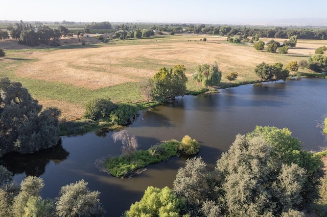 birds eye view of property featuring a water view and a rural view