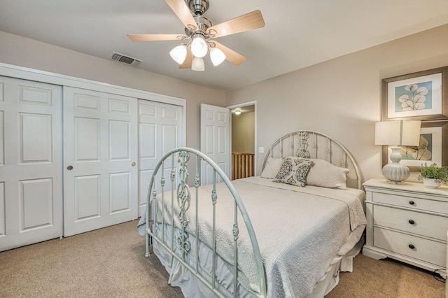 carpeted bedroom with a closet and ceiling fan