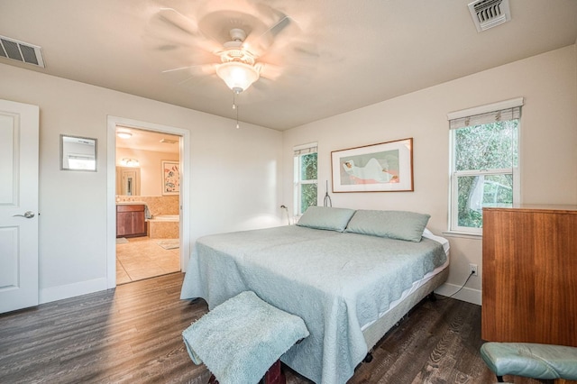 bedroom featuring multiple windows, ceiling fan, and dark hardwood / wood-style floors