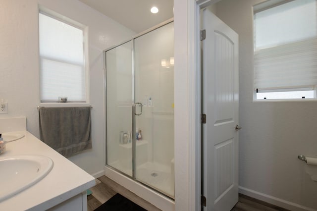 bathroom with vanity, wood-type flooring, and an enclosed shower