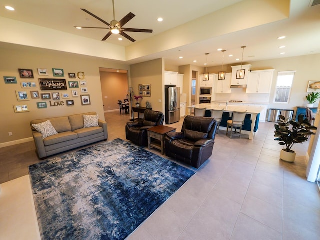 living room with light tile patterned flooring and ceiling fan