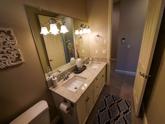 bathroom featuring tile patterned flooring, vanity, and toilet