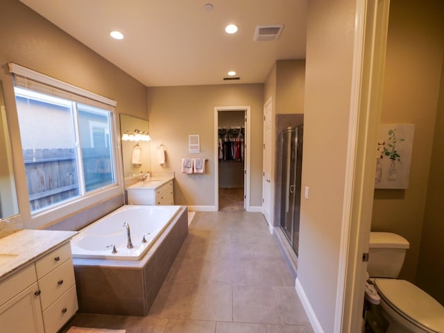 full bathroom featuring vanity, tile patterned floors, independent shower and bath, and toilet