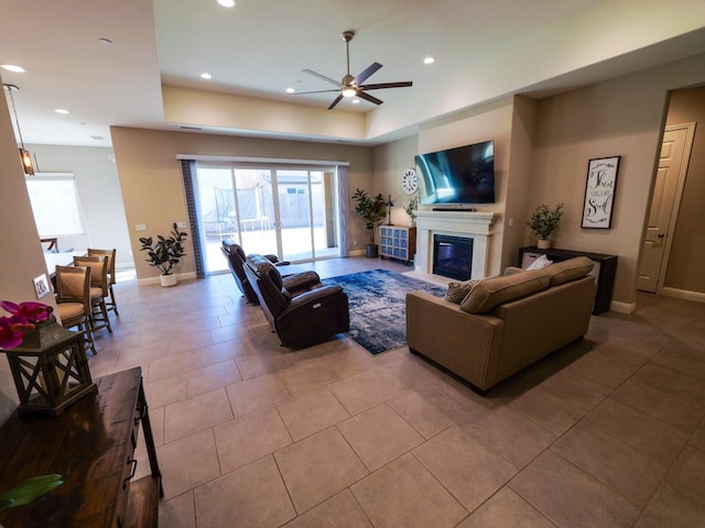 tiled living room with ceiling fan