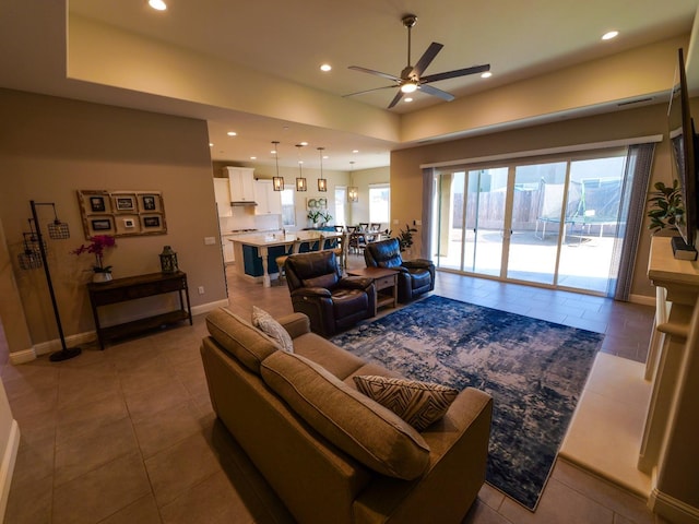 living room featuring tile patterned flooring and ceiling fan