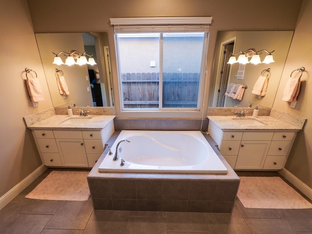 bathroom with vanity, tiled tub, and tile patterned floors