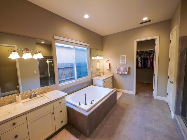 bathroom with vanity, tile patterned flooring, and shower with separate bathtub