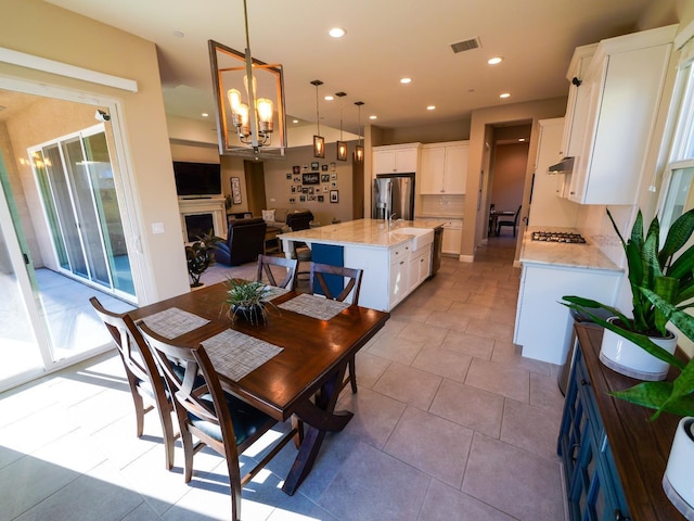 dining area with light tile patterned floors and a chandelier